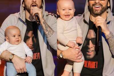 Eminem Shocks Fans by Holding His 3-Month-Old Grandson on Stage Rehearsal — Will We Really See His Grandson on the Upcoming Tour?! We might actually see Eminem’s grandson on the upcoming tour — a revelation that sent chills through the entire crew! It wasn’t a studio session, but the biggest rehearsal of the year. Eminem appeared on stage holding his 3-month-old grandson and performed a completely new rap song. At the chorus, he handed the mic to the baby — whose innocent babbling perfectly matched the beat, bringing everyone to tears. At the end, Eminem whispered something deeply personal and haunting to the fans about what’s coming — leaving the whole team frozen and himself in tears. Is this a farewell? Or a major turning point in his life? WATCH BELOW GET READY TO BE SHOCKED ABOUT HIS UPCOMING TOUR!