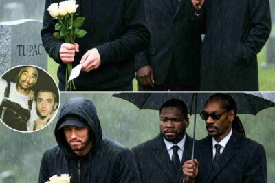 “Eminem Breaks Down in Tears at Tupac’s Grave — 50 Cent and Snoop Dogg Stunned by Final Wish Left Unfulfilled! During a private visit to Tupac’s resting place, Eminem couldn’t hold back his emotions as he discovered a mysterious KEEPSAKE left just for him — one no one knew existed. Standing beside 50 Cent and Snoop Dogg, the rap legend was visibly shaken when learning of Tupac’s final wish… a dream he never got to fulfill. What was written on that old, weathered envelope has left the hip-hop world stunned.