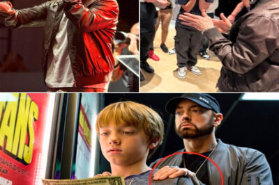 “The One-Dollar Boy at Eminem’s Stan Premiere: A Cold Detroit Night, a Torn Bill, and the Stranger’s Whisper That Shocked an Entire Crowd Into Silence”!Late autumn wrapped Detroit in icy breath as the neon glow of Stan lit up the Regal Grand cinema. Among the glittering celebrities, flashing cameras, and roaring fans stood Noah—a frail boy clutching a single torn dollar like it was his lifeline. Just a few coins short of entering the world where his idol awaited, he turned to leave, his dream collapsing under the weight of poverty. But destiny is never quiet. A hand touched his shoulder. A low voice cut through the wind: “Hey, boy…” What happened next froze the street. Whispers spread, phones flew up, and within minutes, the premiere of Stan became the backdrop to one of the most shocking, unforgettable encounters in Eminem’s story.