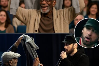 “He held it high above his head… and Eminem finally told the truth.” — The night a worn-out hoodie revealed a story of survival and kindness.