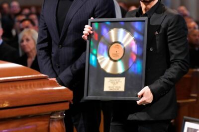 “Eminem Flew Ozzy’s First Gold Record Across the Atlantic for the Funeral — But the Chilling Words Secretly Carved Into the Back Left Even Dr. Dre in Tears”!It wasn’t just a gift — it was a secret decades in the making. At Ozzy Osbourne’s funeral, Eminem had the metal icon’s very first UK gold record flown in under armed guard, wrapped in black velvet. But when the crowd saw the back, everything changed. Etched deep into the metal were chilling words only three people on earth had ever heard before — a line pulled from an unreleased verse Ozzy inspired in 1996. Dr. Dre’s hands shook. Sharon Osbourne gasped. And for a moment, the entire room was silent, as if the message had summoned a ghost.