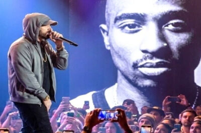On the Anniversary of Tupac’s Death, Eminem Delivered a Soul-Stirring Tribute That Silenced 30,000 Fans — A Raw, Heartbreaking Performance That Bridged Life and Death, Defied Time, and Rekindled the Spirit of a Legend Who Still Speaks From Beyond! On the solemn anniversary of losing a street prophet, Eminem stepped onto the stage and transformed a concert into a sacred moment. As the haunting opening of “Changes” filled the air, the arena froze — thirty thousand souls united in reverence and raw emotion.